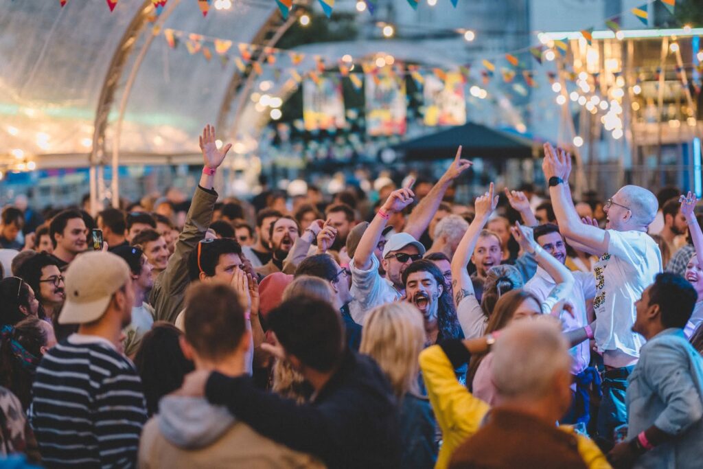 Friends laughing over festival beers — BBP Wanderlust