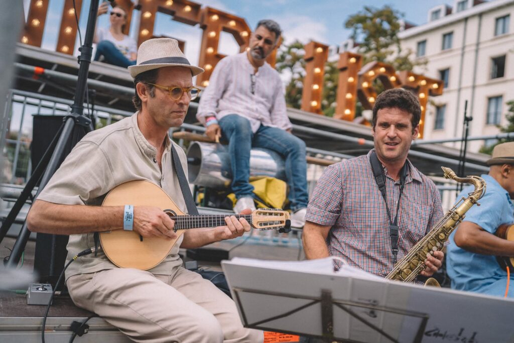 Musicians playing under the Wanderlust letters