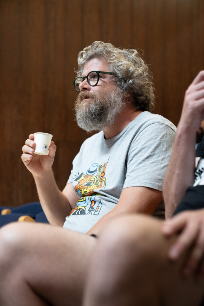 Brewer holding a tasting cup during the masterclass